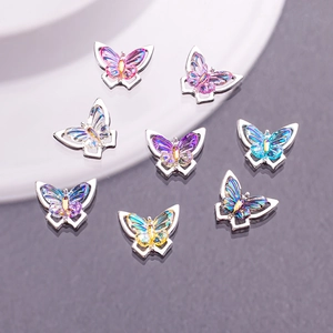 Macro view of 8pcs colorful gradient butterfly nail art charms with silver metal frames