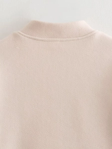 Close-up of the beige wool jacket neckline showing clean stitching and soft fabric texture