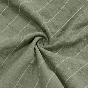 Detailed macro shot of army green striped fabric texture with breathable cotton feel