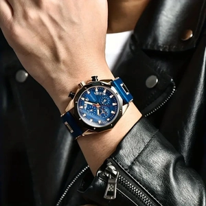 Men's blue chronograph sport watch with rose gold case and silicone strap on wrist