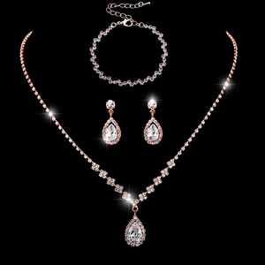 Elegant rose gold bridal jewelry set featuring teardrop crystals and sparkling rhinestones