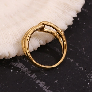 Detail showing an 18K gold-plated double-layer hollow ring on white coral piece