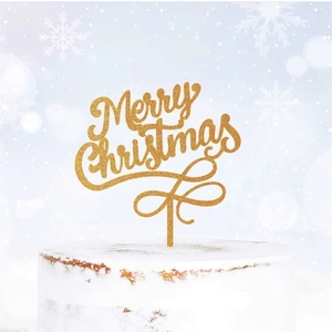 Close-up of golden glitter Merry Christmas acrylic cake topper on white frosted cake