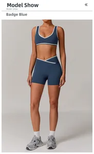 Detail of cross high-waisted shorts and crest blue sports bra with white contrast piping