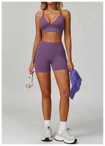 Detailed close-up of matte purple seamless yoga set fabric and high-waist stitching finish