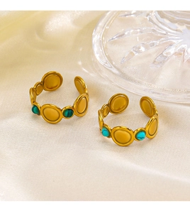 Detail of adjustable gold-plated rings with green malachite and blue turquoise stones