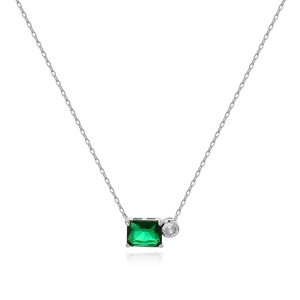 Close-up of emerald square gem and round clear stone on silver necklace pendant
