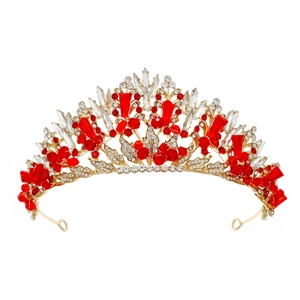 Luxurious bridal tiara with sparkling red and clear crystals on a white background