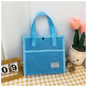 Detail of light blue mesh tote bag showing fabric texture and snap closure mechanism