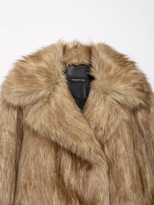 Detailed close-up showing texture and quality of tan faux fur coat collar