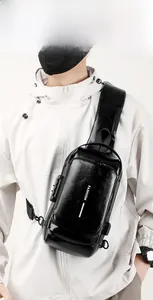 Detail showing anti-theft combination lock on black leather men's chest sling bag