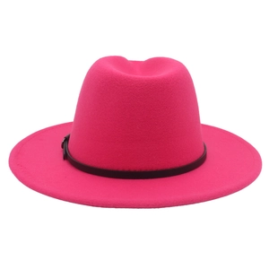 Detail of fuchsia wide brim fedora hat featuring a slim black leather belt with metal buckle