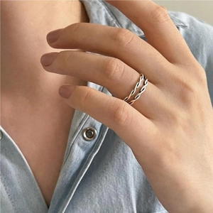 Double-layered twist rope sterling silver open ring set worn on finger in minimalist style