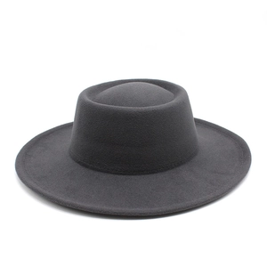 Top view of dark grey wool felt boater hat with a flat brim and wide crown detail