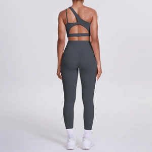 Rear view of dark grey one-shoulder yoga bra with geometric cutout and matching leggings