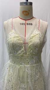 Detail of V-neck lace wedding dress with silver sequins and floral embroidery texture