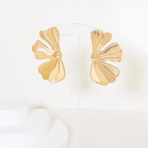 Detailed close-up of golden petal-shaped earrings with high-polish metallic finish