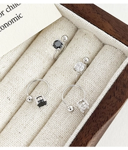 Detailed view of silver and gunmetal ear cuffs with round and square cubic zirconia