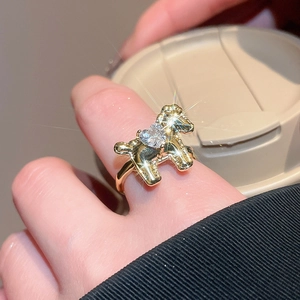 Macro shot of gold puppy ring featuring a heart-shaped zircon and sparkly crystal accents