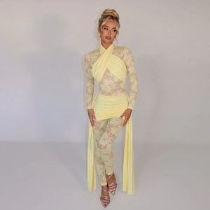 Detailed view of yellow lace bodysuit featuring waist wrap drapery and elegant silhouette