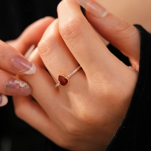 Macro view of 18k gold plated ring with red heart gemstone and micro-pave crystals