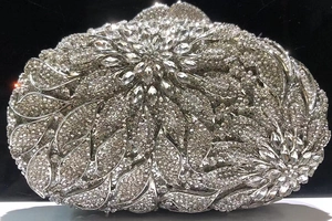 Close-up of silver floral crystal evening clutch bag with intricate rhinestone detailing
