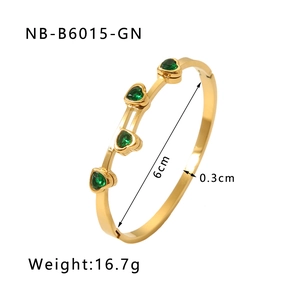 Detail view of 18K gold plated steel bangle with green heart zircons and size markings