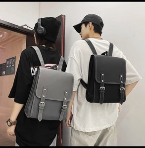 Gray and black faux leather backpacks with classic flap and buckle straps for students