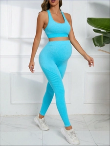 Detail of sky blue seamless maternity yoga set with high waist pants and sports bra