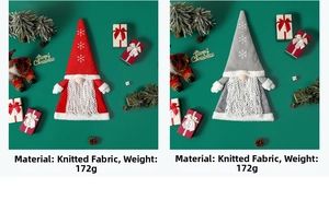 Detail of red and grey knitted Christmas gnomes with snowflake embroidery and soft beards