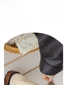 Close-up of white ruffled edge socks with delicate knitted texture in a rustic basket