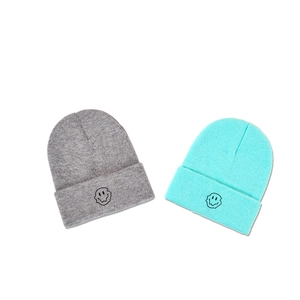 Knitted beanie with melting smiley face embroidery in grey and cyan green colors
