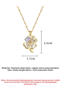 Macro shot of titanium steel four-leaf clover necklace with gold finish and zircon inlay
