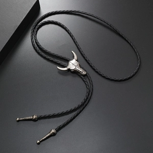 Detail of silver bull head bolo tie buckle with black braided faux leather rope