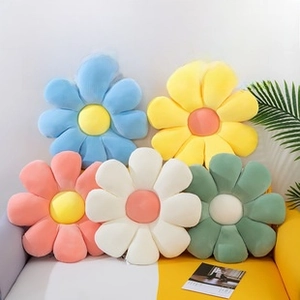 Detailed pile of colorful flower plush cushions in blue, yellow, pink, white, and green