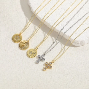 Detail of 14K gold and silver plated cross necklaces with sparkling zircon pendants