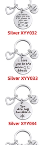 Three polished stainless steel keychains with heart charms and engraved love quotes