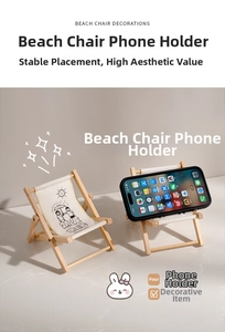 Detail of a mini folding beach chair phone stand featuring cute canvas illustrations