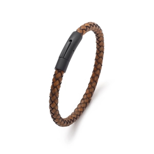 Close-up of brown braided leather bracelet with a matte black metal clasp