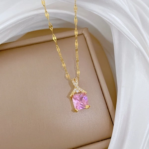Detail of square pink gemstone pendant with diamonds on a wavy gold chain