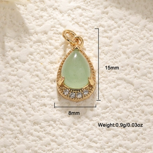 Detail view of a 15mm pear-shaped green gemstone pendant with 18K gold-plated textured frame