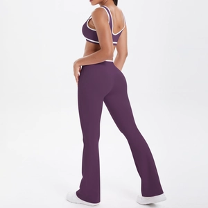 Two-piece deep purple flared yoga set with contrasting white trim and racerback top