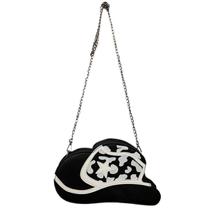 Detail of black cowboy hat shaped crossbody bag with star pattern and metal chain