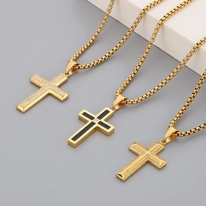 Detailed view of gold stainless steel cross pendants with rhinestones and fine engraving