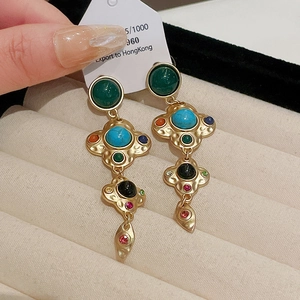 Detailed macro view of vintage baroque tassel earrings featuring colorful zircon stones