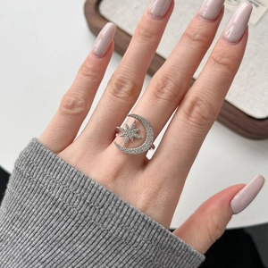 Close-up of S925 sterling silver moon and star ring with sparkling cubic zirconia stones
