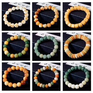 Detail showing various carved Bodhi seed beads in cat paw and round shapes