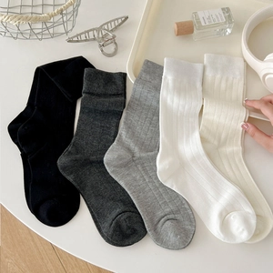 Five pairs of rib-knit mid-calf socks in grey, white, and black neutral colors