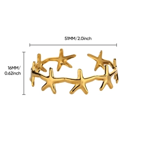 Detailed close-up of a gold starfish cuff bracelet featuring hollow nautical design elements