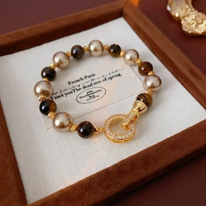 Vintage gold plated geometric beaded bracelet featuring tiger eye stones and pearls